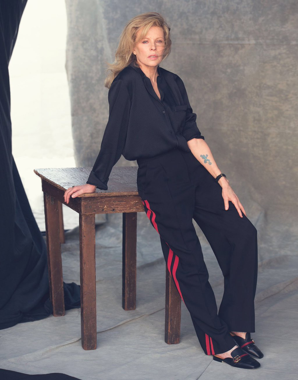 Kim Basinger by David Bellemere. Shirt by Barbara Casasola, pants by Alexander McQueens, shoes by Gucci, watch by Larsson & Jennings